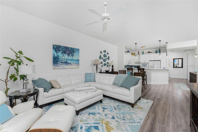 11100 Hacienda Del Mar Blvd Unit 202, Placida, FL 33946 - living room featuring a ceiling fan, baseboards, and light wood-style flooring