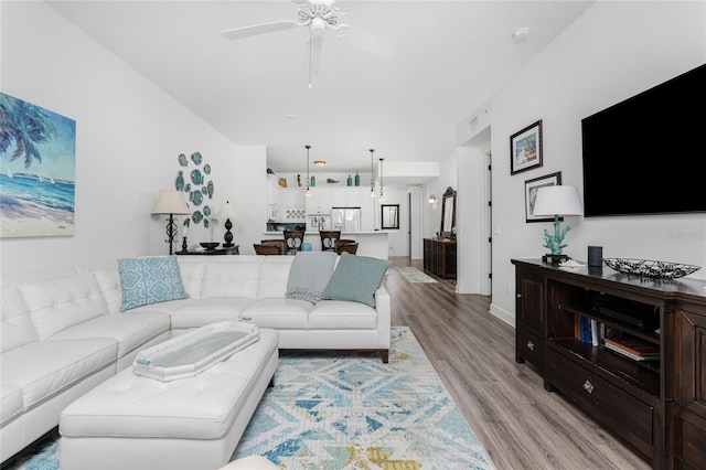 11100 Hacienda Del Mar Blvd Unit 202, Placida, FL 33946 - living area with a ceiling fan, light wood-style flooring, and baseboards