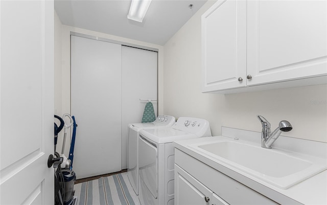 11100 Hacienda Del Mar Blvd Unit 202, Placida, FL 33946 - washroom with cabinet space, a sink, and washer and clothes dryer