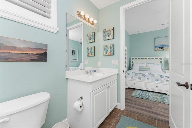 11100 Hacienda Del Mar Blvd Unit 202, Placida, FL 33946 - ensuite bathroom featuring toilet, vanity, connected bathroom, and wood finished floors