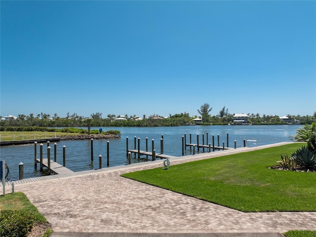 11100 Hacienda Del Mar Blvd Unit 202, Placida, FL 33946 - dock area featuring a water view and a yard