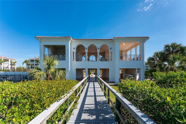 11100 Hacienda Del Mar Blvd Unit 202, Placida, FL 33946 - rear view of property with stucco siding and a tiled roof