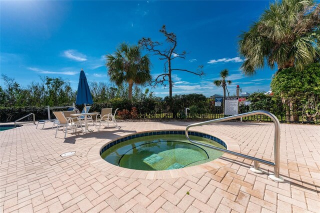 11100 Hacienda Del Mar Blvd Unit 202, Placida, FL 33946 - view of swimming pool featuring a community hot tub, fence, and a patio