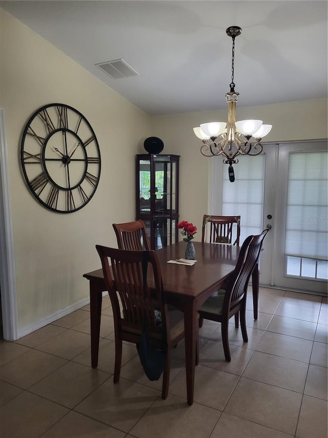 dining area featuring an inviting chandelier, tile patterned floors, and a wealth of natural light