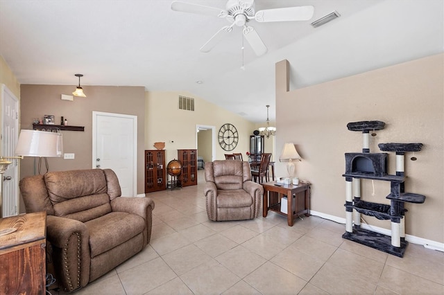 living room with light tile patterned floors, visible vents, and vaulted ceiling