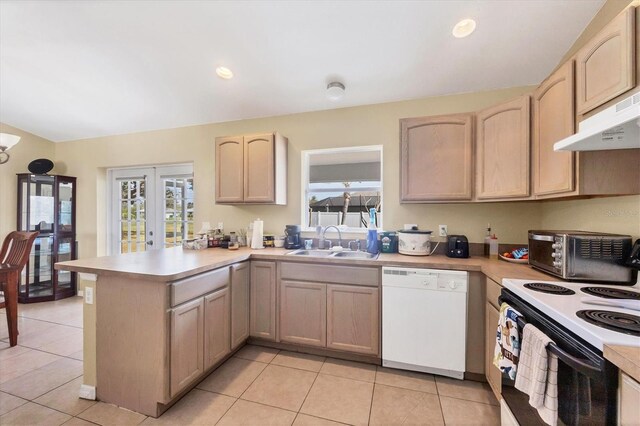 kitchen featuring light countertops, a sink, range with electric cooktop, dishwasher, and a peninsula