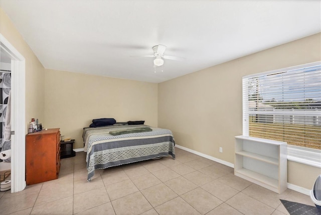 bedroom featuring ceiling fan, baseboards, and light tile patterned flooring