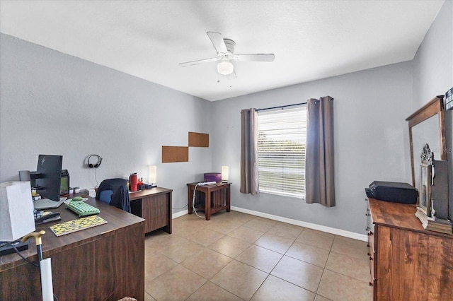 office with light tile patterned floors, a ceiling fan, and baseboards