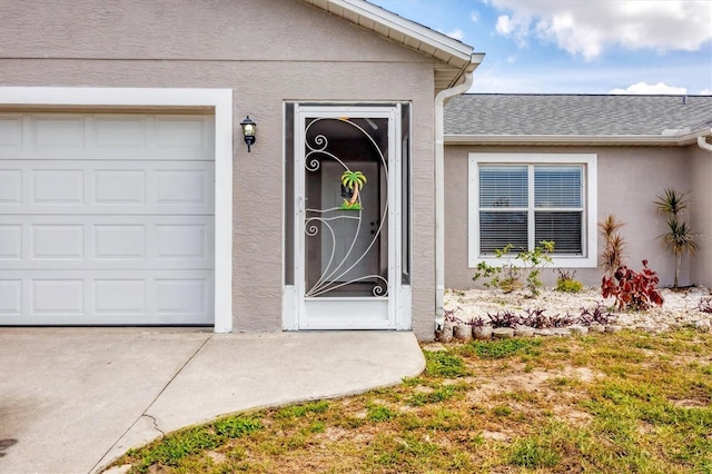 doorway to property with a garage, roof with shingles, and stucco siding