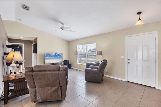 living area with visible vents, a ceiling fan, light tile patterned flooring, vaulted ceiling, and baseboards