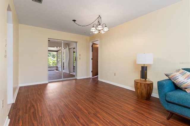 interior space with dark hardwood / wood-style flooring and a notable chandelier