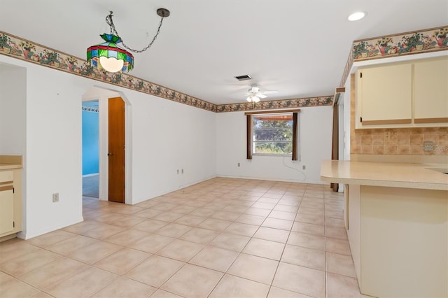 interior space with ceiling fan and light tile patterned floors