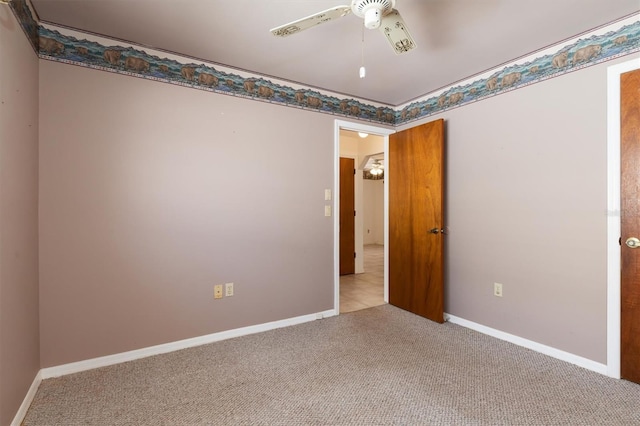 unfurnished room with ceiling fan and light colored carpet