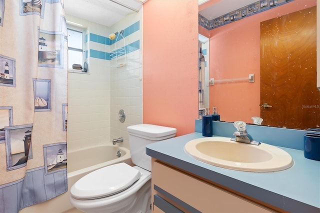 full bathroom featuring tiled shower / bath combo, vanity, and toilet