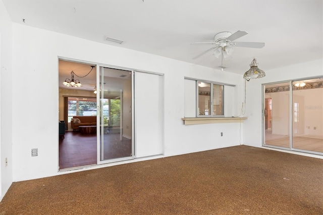 empty room featuring ceiling fan and carpet