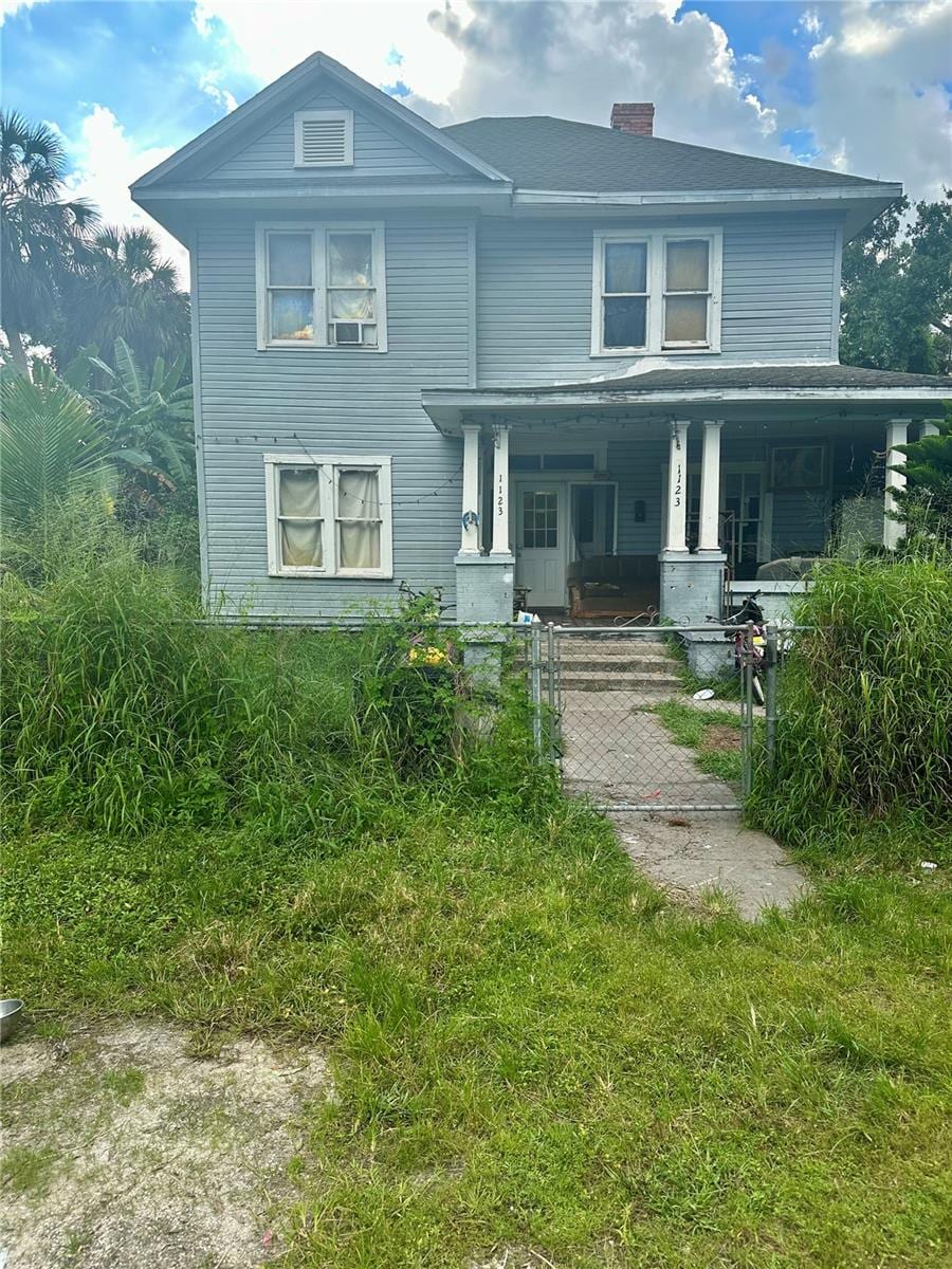 view of front of home with a front yard and covered porch