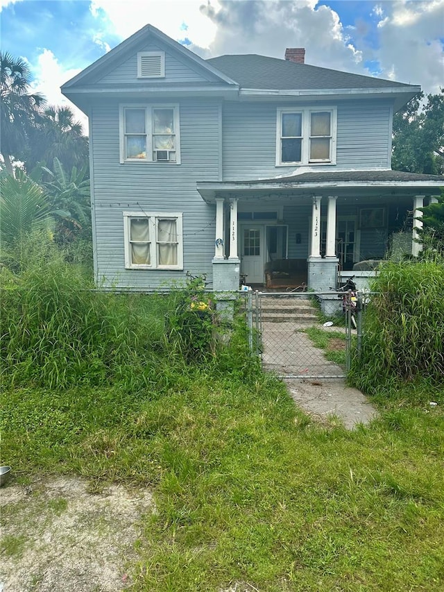 view of front of home with a front yard and covered porch