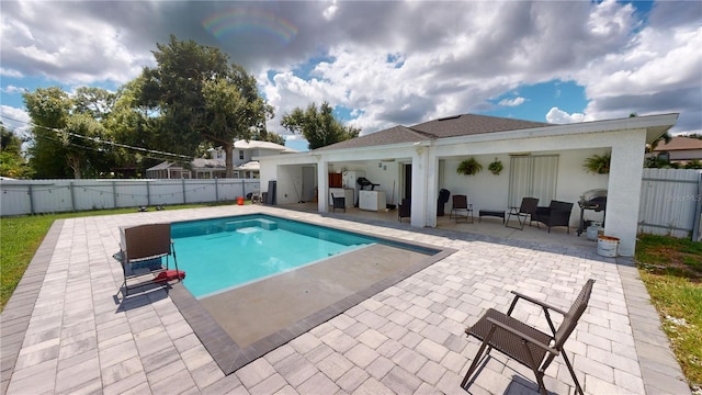 view of swimming pool with a patio area