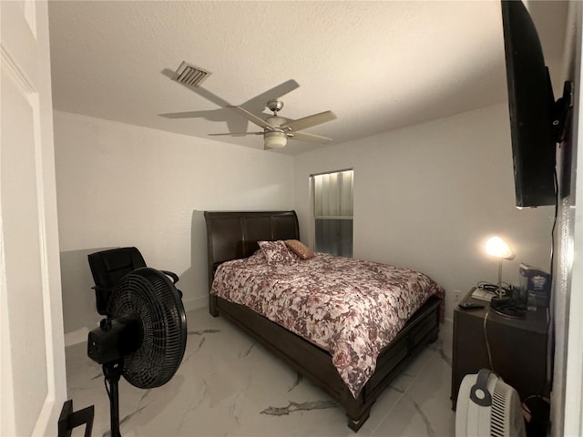 bedroom featuring a textured ceiling and ceiling fan