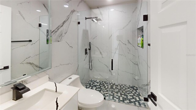 bathroom with vanity, toilet, and an enclosed shower