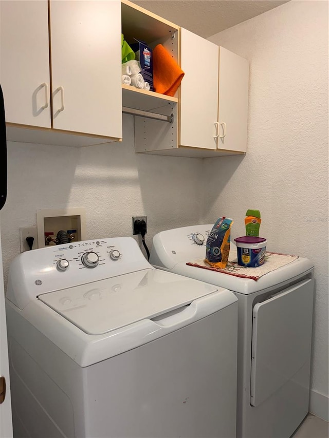 laundry area featuring independent washer and dryer and cabinets