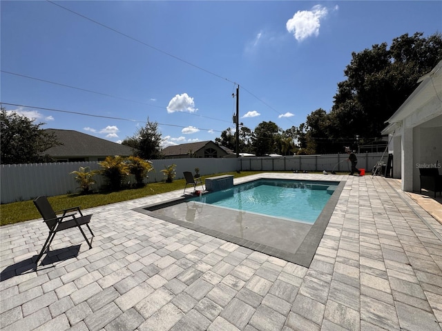 view of swimming pool with pool water feature and a patio area