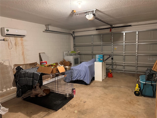 garage featuring a garage door opener, washer / clothes dryer, and a wall unit AC