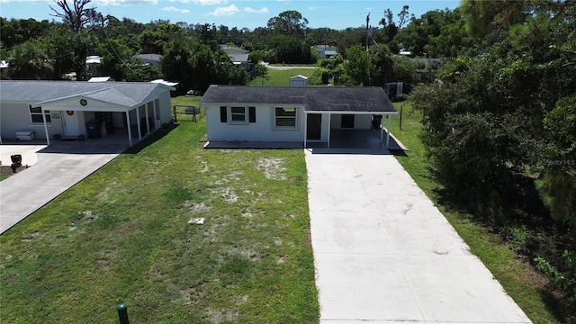 ranch-style home featuring a front yard and a carport