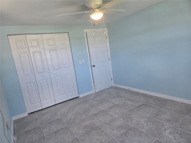 unfurnished bedroom with tile patterned floors, a closet, and ceiling fan