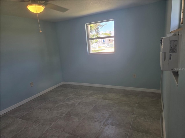 tiled empty room with ceiling fan