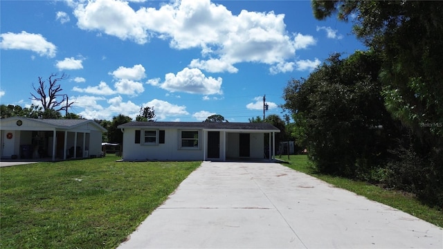 view of front of home with a front yard and a carport