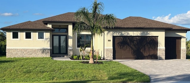 view of front of property with a garage and a front yard