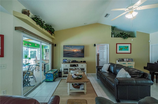 tiled living room featuring ceiling fan and vaulted ceiling