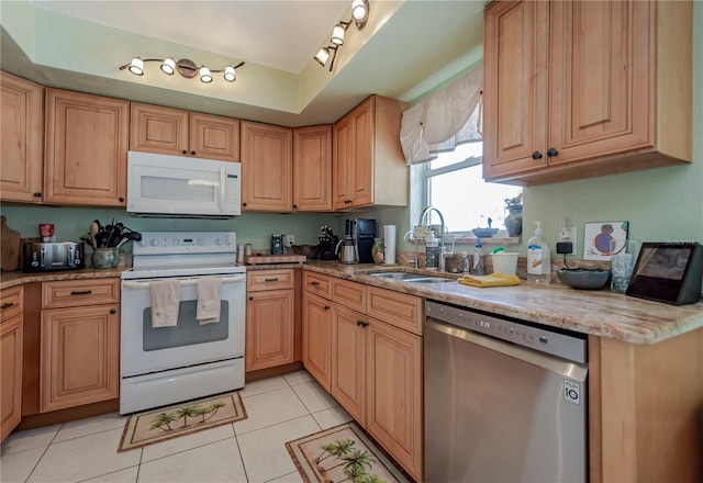 kitchen featuring light tile patterned flooring, light stone countertops, sink, and white appliances