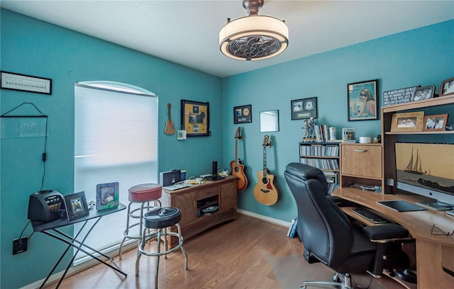 home office featuring baseboards and wood finished floors