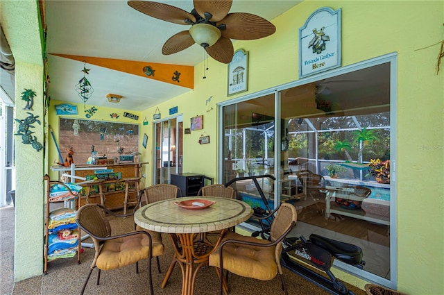 sunroom with ceiling fan and lofted ceiling