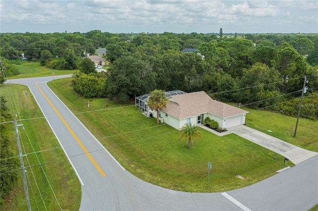 birds eye view of property with a view of trees