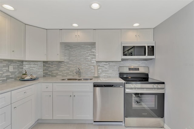 kitchen with white cabinets, stainless steel appliances, and sink