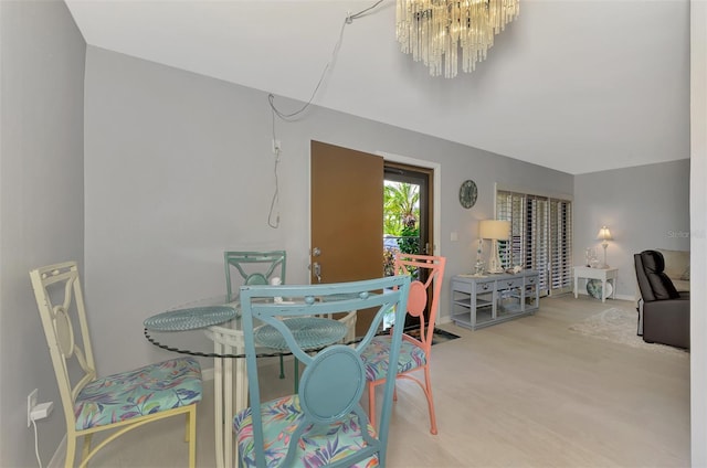 carpeted dining space featuring an inviting chandelier