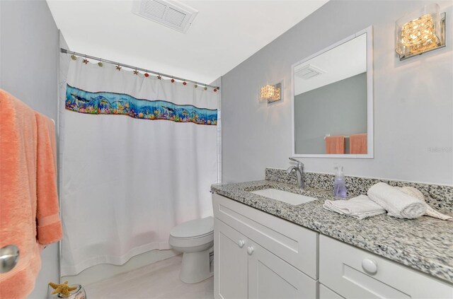 full bathroom with shower / bathtub combination with curtain, vanity, and toilet