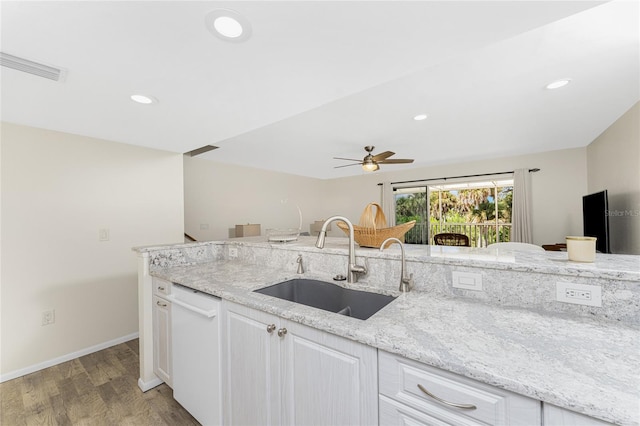 kitchen featuring light stone counters, sink, light hardwood / wood-style flooring, dishwasher, and white cabinetry