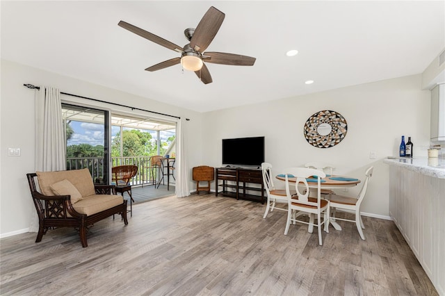 dining area featuring ceiling fan and light wood-type flooring