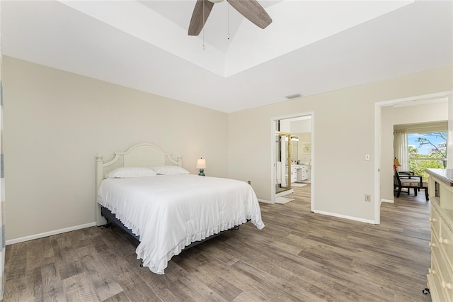 bedroom with ceiling fan, dark hardwood / wood-style flooring, lofted ceiling, and ensuite bathroom