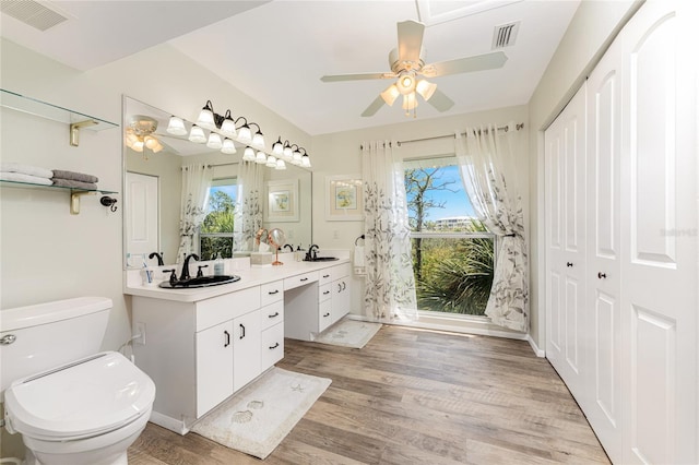 bathroom featuring hardwood / wood-style floors, vanity, a wealth of natural light, and ceiling fan