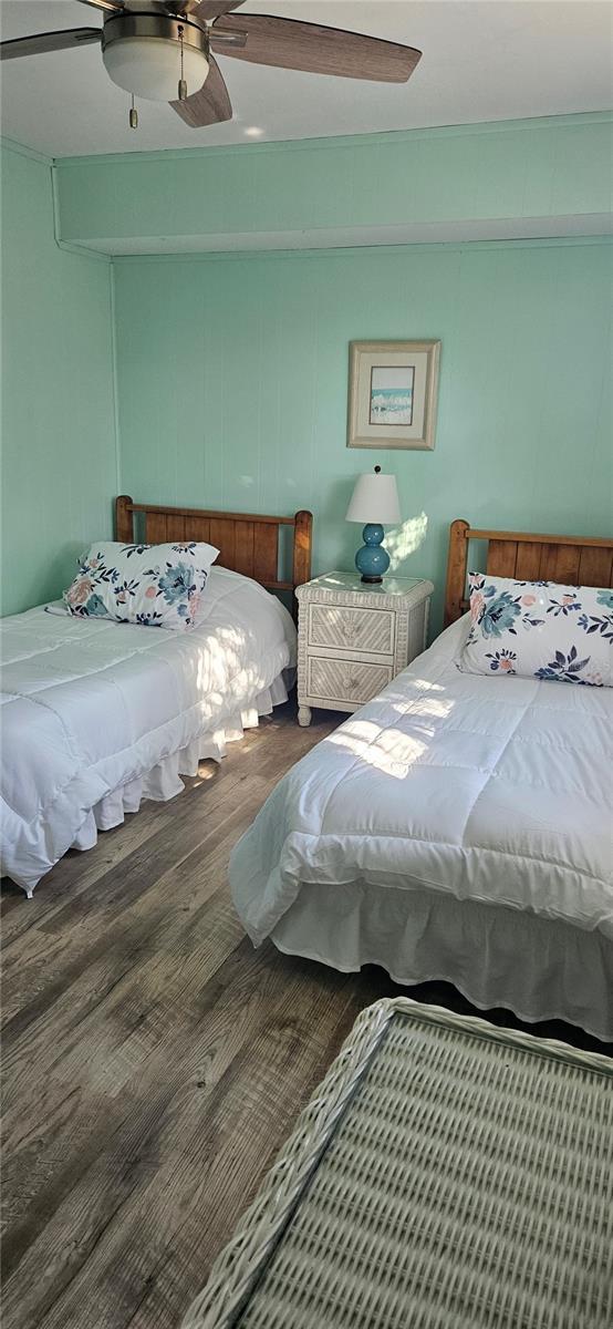 bedroom featuring wood-type flooring and ceiling fan