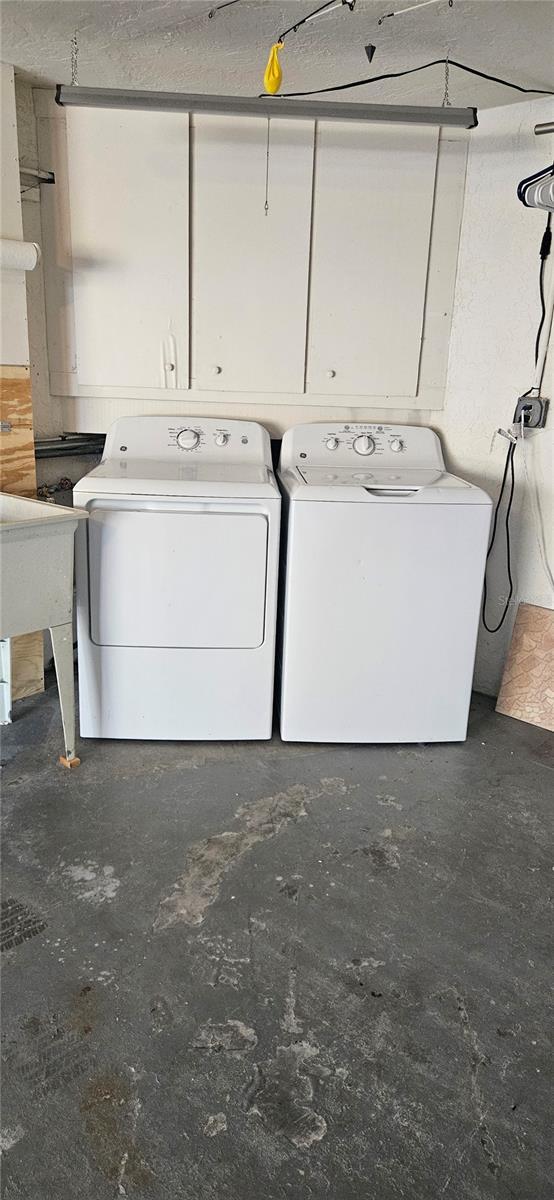 clothes washing area featuring washer and dryer