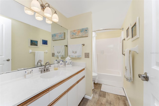 full bathroom featuring vanity, toilet, wood-type flooring, and shower / tub combo