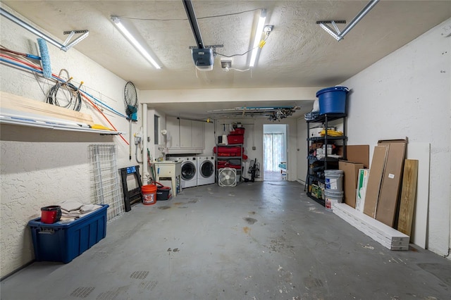 garage featuring washer and dryer and a garage door opener