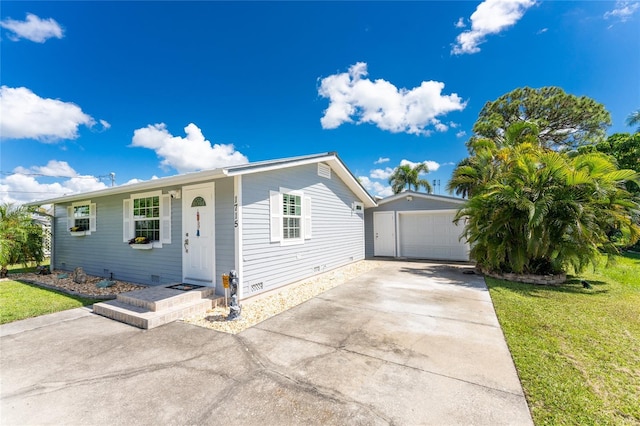 single story home with an outdoor structure and a front lawn