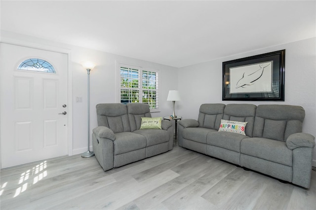 living room featuring baseboards and light wood finished floors